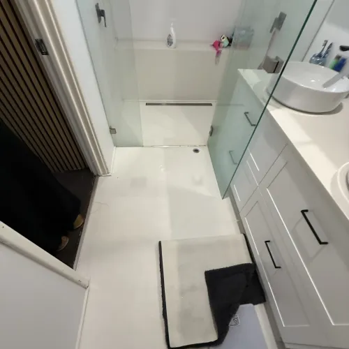 Bathroom renovation with a frameless glass shower and vessel sink vanity